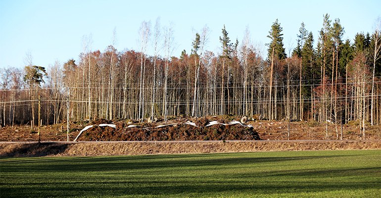 A pile of logging residues at roadside, covered with a paper wrap to aid air drying, will be used for energy at a local biomass-fired heat plant and/or combined heat and power (CHP) plant.